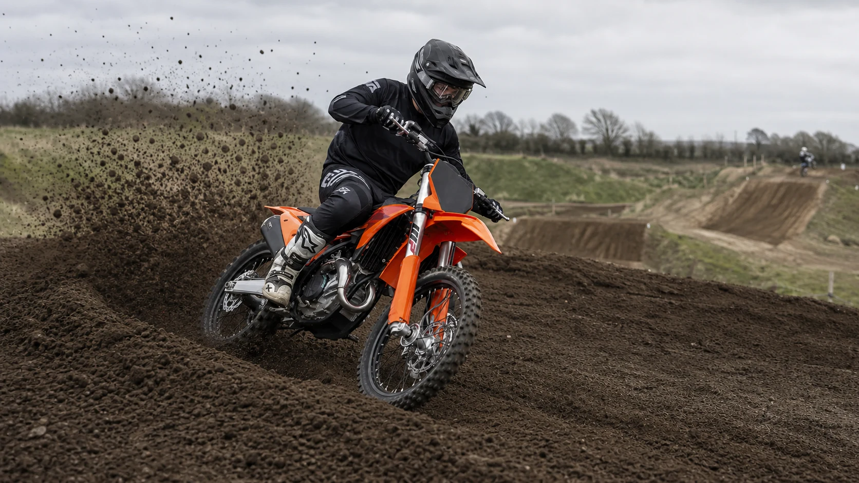 A rider carving a British practice-track berm on a KTM 450 SX-F